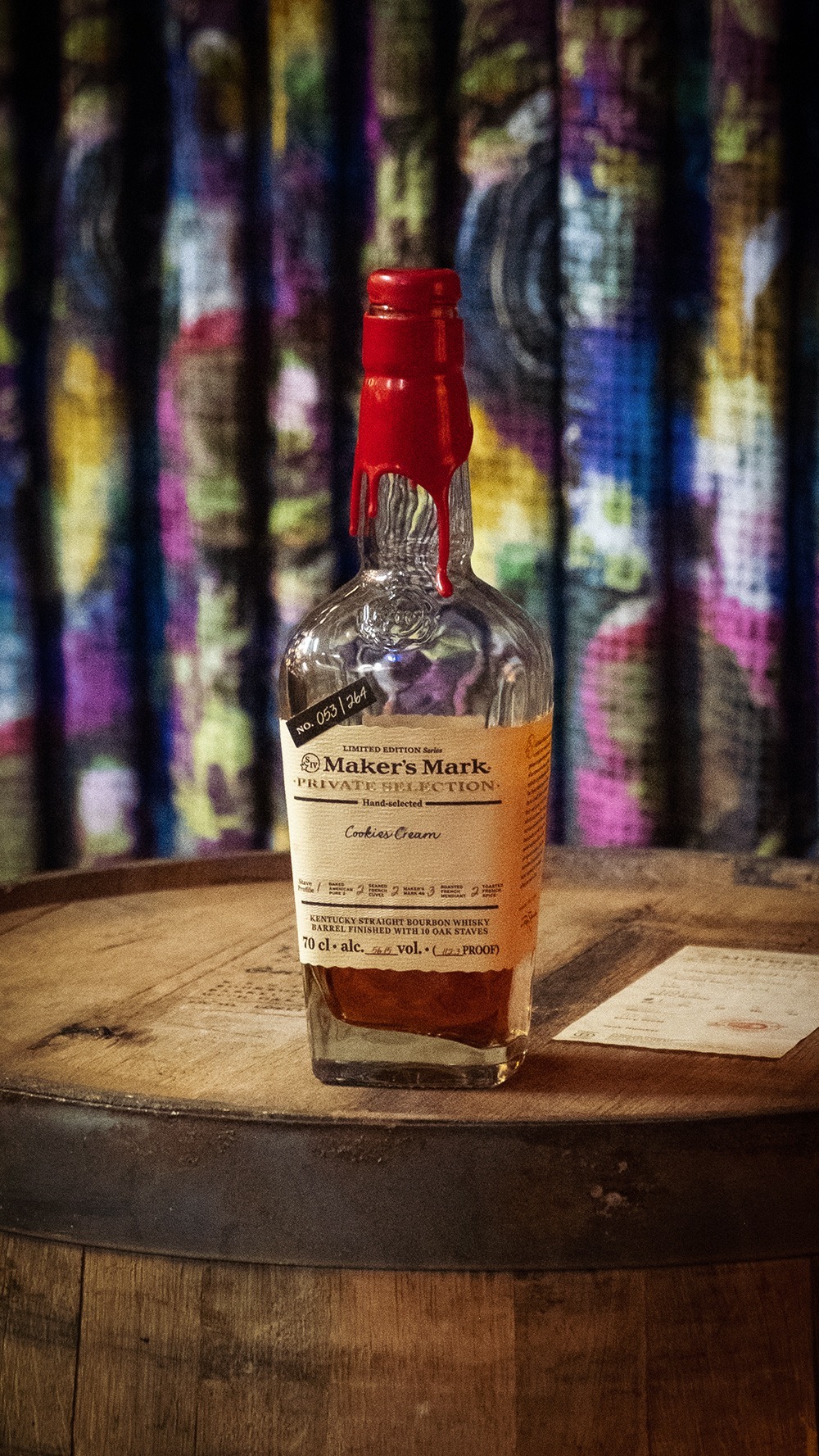 A bottle of Marker's Mark with the red wax seal and a Cookies Cream Label